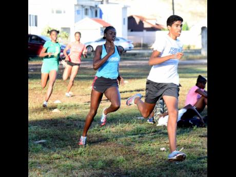 Zico Bennett (right) and teammate Oneika McAnuff during a Hydel High school training session as they prepare for Champs.