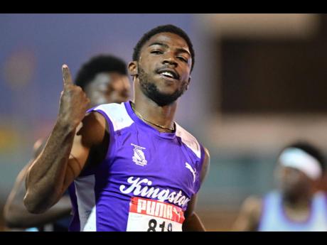 Kingston College's (KC) Bouwahjgie Nkrumie celebrates after breaking the Class One boys' 100 metres record at the ISSA/GraceKennedy Boys and Girls' Athletics Championships at the National Stadium on tonight. The final is set for later tonight.