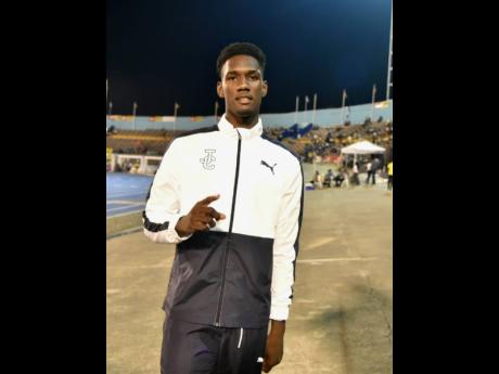 Jamaica College's (JC) Uroy Ryan enjoys his victory in the Class One boys' long jump at the ISSA/GraceKennedy Boys and Girls' Athletics Championships at the National Stadium earlier tonight.