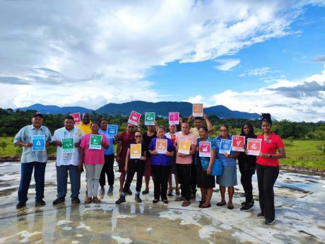 Indigenous people from the Surama Village in Guyana share cards with the 17 SDGs in a photo shoot following the recent BNTF assessments.