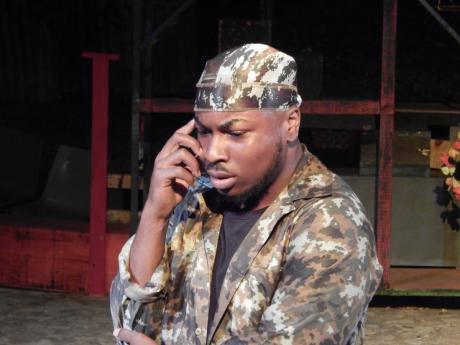 Macbeth (Trevon Robinson) on the phone to his wife, in one of the modern touches to the play. 