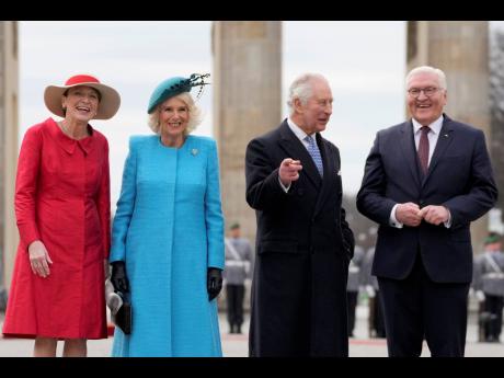 German President Frank-Walter Steinmeier (right), and his wife Elke Buedenbender (left), welcome Britain’s King Charles III and Camilla, the Queen Consort, in front of the Brandenburg Gate in Berlin, on Wednesday.