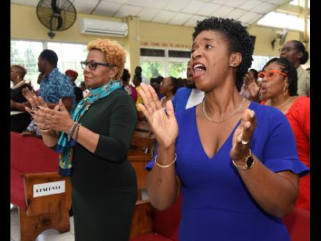 Dr Maureen Dwyer (left), acting permanent secretary in the Ministry of Education and Youth, and National Mathematics Coordinator Dr Tamika Benjamin worshipping during the National Mathematics Week church service at the Clifton New Testament Church of God o