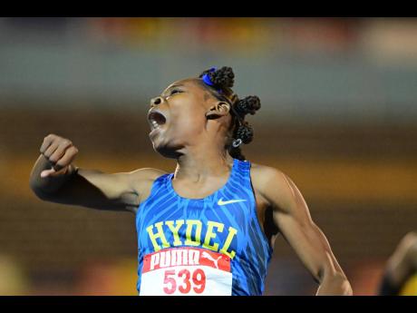 Alana Reid of Hydel High School reacts after clocking 10.92 seconds to shatter the Class One 100m record of 11.13 seconds set by Veronica Campbell in 2001 at the ISSA/GraceKennedy Girls and Boys’ Athletics Championships on Wednesday.