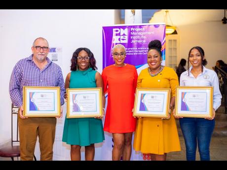 PMI Jamaica President Avalyn Minott (centre) with (from left) representatives of Democracy International, Jamaica Association for the Deaf, the Planning Institute of Jamaica (PIOJ) and the Jamaica Environment Trust,(JET) recipients of the change-maker awar
