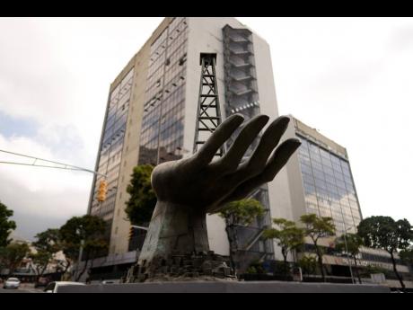 AP 
A sculpture of a hand holding an oil well stands by the state-run oil company PDVSA (Petroleos de Venezuela SA) in Caracas, Venezuela.