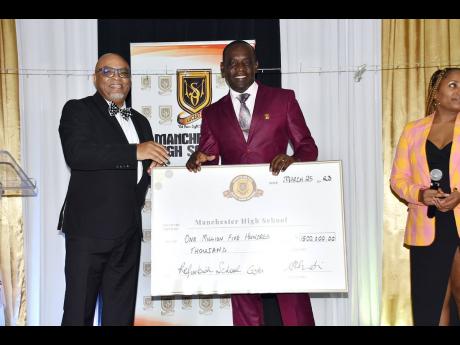 From left; President of the Manchester High School Global Alumni Network, Dr Lundie Richards presents a cheque of $1.5 million to Manchester High School Principal Jasford Gabriel at the recent Global Alumni Network homecoming gala held at the Golf View Hot