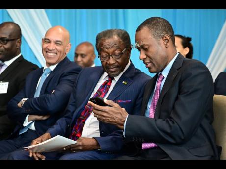 From left: Police Commissioner Major General Antony Anderson looks on as United States Ambassador Nick Perry and Minister of Finance and the Public Service interact during the the opening ceremony for the United States-Jamaica Advanced Counter Gang Trainin