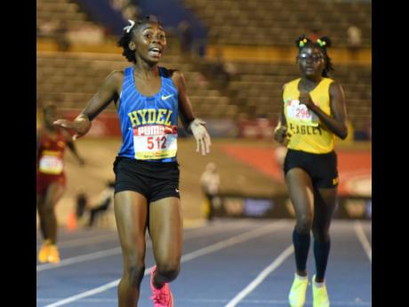
Hydel High's Nastassia Fletcher (left) celebrates her win in the Class Three girls'  400 metres final ahead of Breana Brown (right) of Excelsior High at the National Stadium on Thursday night. Fletcher won in 53.99 seconds.