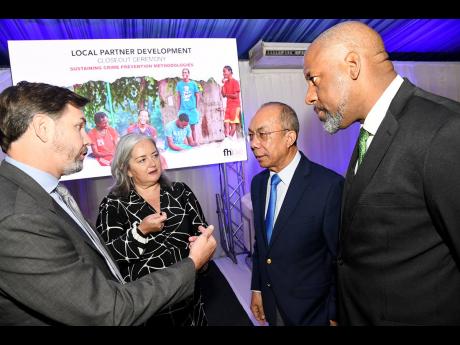 Deputy Prime Minister and Minister of National Security Dr Horace Chang (second right) speaks with (from left) Alex Gainer, acting USAID country representative to Jamaica; acting United States Agency for International Development, Morana Smodlaka Krajnvic,
