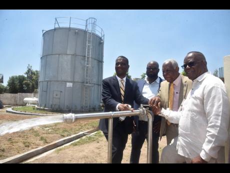 (From left) Dr. Asburn Pinnock, President, The Mico University College, Weston Jones, Project Engineer, Dr. R. Karl James, Chancellor, Lady Mico Trustee, and Dr Sylvester Tulloch, chairman, The Mico Foundation, open the valve of The Mico Independent Water 