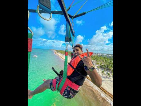 With clear open skies above and wonderful waters below, the businessman basks in the bliss of parasailing in Punta Cana.