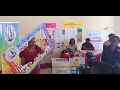 Education Minister Fayval Williams poses with a chart during the Early childhood Commission’s regional certification fair in Port Maria, St Mary, last Thursday.