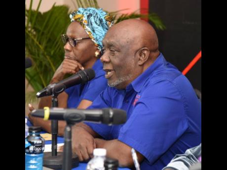 Head coach at Racers Track Clup and meet director of the Racers Grand Prix, Glen Mills (right), speaks to media during the launch of the June 3 event at the Jamaica Pegasus Hotel earlier today. Looking on is former principal of Camperdown High School, Cynt