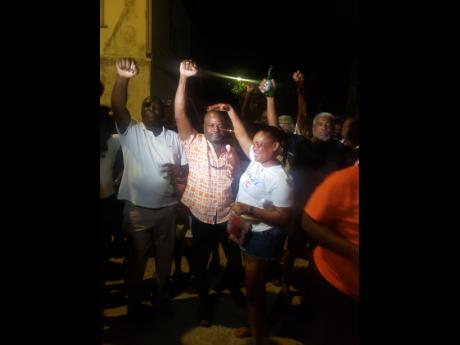 Dennis Meadows (centre) being welcomed into the People’s National Party at the Falmouth Divisional Conference at Falmouth All Age School in Falmouth, Trelawny, on Sunday night, July 3, 2022.