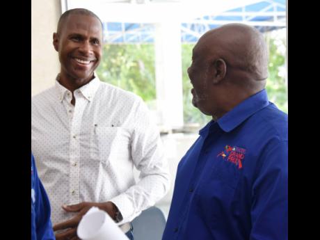Bruce James (left), director, World Class Athletics,  and Glen Mills, meet director of Racers’ Grand Pris share a light moment just ahead of the launch of the Racers’ Grand Prix at the Jamaica Pegasus Hotel yesterday.
