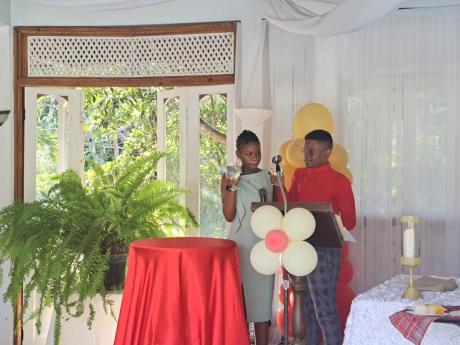 Shaneilia Shaw and Jayden Emery, grade-seven students of Muschett High School in Wakefield, Trelawny, raise a toast to their teachers during the school’s fifth annual Grade Seven Luncheon at the Day O Plantation in Granville, St James, on Tuesday, April 