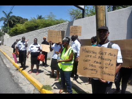 Several placard-bearing guards took their grievances to the downtown Kingston offices of the Ministry of Labour and Social Security on Thursday, claiming that the new contracts being offered to them, which would see them now being recognised as employees, 