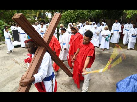 The Missionaries of the Poor brothers doing a re-enactment of the 14 stations of the cross on North Street in Kingston on Good Friday. While many Christians still observe the religious significance of the season locally, there are concerns that it is losin