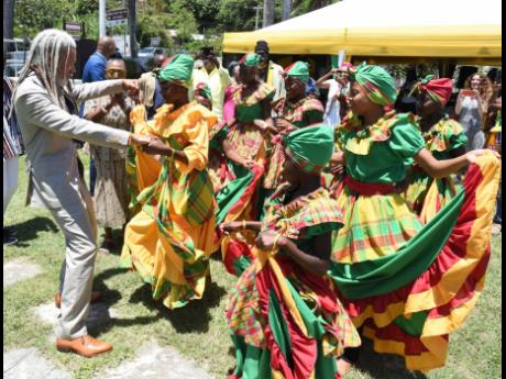Dr. Vincent Brown (left), Charles Warren professor of American history and professor of African and African American Studies at Harvard University in the United States, dances during the St Mary Municipal Corporation’s civic ceremony to commemorate Natio