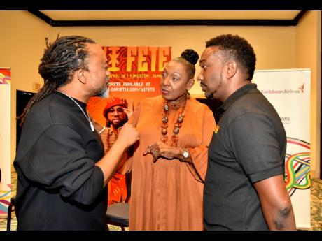 From left: Trinidadian soca singer, record producer and songwriter, Machel Montano, in discussion with Minister of Culture, Gender, Entertainment and  Sport, Olivia Grange and Aldwyn Wayne, founder of WiPay, during the WiFete press conference in March at T