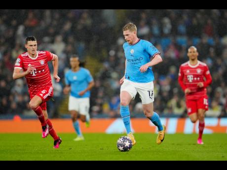 Manchester City’s Kevin De Bruyne (second right) runs with the ball past Bayern’s Benjamin Pavard during their Champions League quarterfinal, first leg, football match at the Etihad stadium in Manchester, England yesterday.