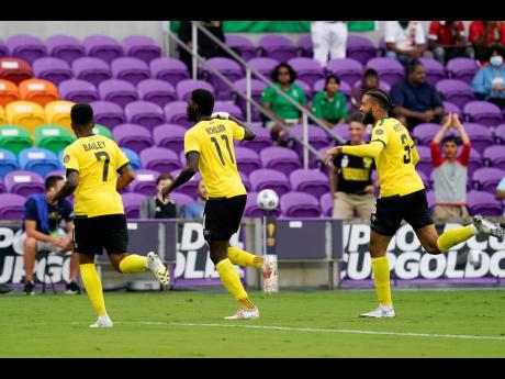 Reggae Boy Shamar Nicholson (11) celebrates after scoring a goal against Suriname with teammates Leon Bailey (7) and Michael Hector (3) during the first half of a Concacaf Gold Cup Group C  match on Monday, July 12, 2021, in Orlando, Florida.