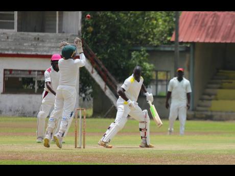 PHOTO BY 
St Catherine CC wicketkeeper Oraine Williams (left) throws the ball up in celebration after taking a catch to remove St Mary batsman Sheldon Pryce for 10, off the bowling of Peat Salmon, during the opening day of their JCA Senior Cup quarter-fina