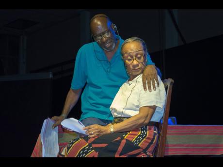 Grace McGhie (foreground) and Winston ‘Bello’ Bell during a recitation of Trevor Rhone’s ‘Two Can Play’, at the Standing Ovation Concert held at the National Arena in Kingston in 2017.