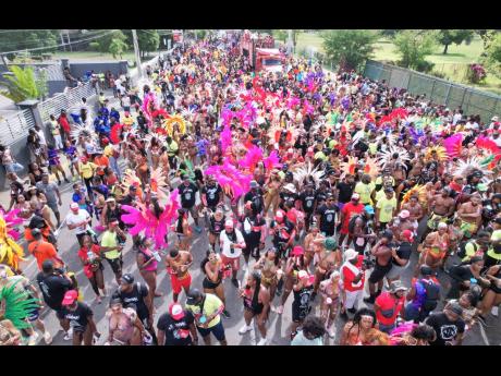  Aerial view of carnival revellers along Hope Road on Sunday.