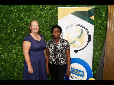Evelyn Harrington (left), chief executive officer, Fargo Electronics, Montego Bay Free Zone, and Gloria Henry, vice-president, business processing outsourcing and logistics, Port Authority of Jamaica, enjoy a moment at the corporate launch of the Outsourci