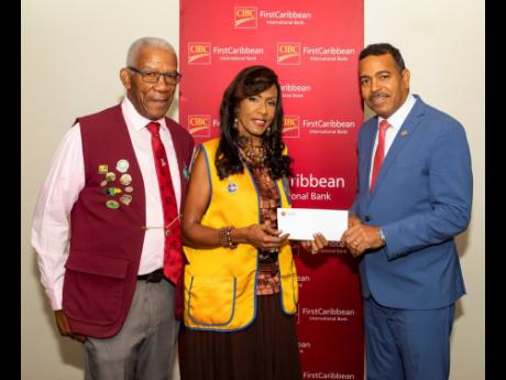 The Sight Clinic and Building Fund and charities of the Lions Club of Kingston are the beneficiaries of a contribution from the CIBC FirstCaribbean International Bank. Here, Managing Director Nigel Holness (right) presents a cheque to Errol Lee, Lions past