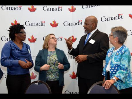 From left: Bridgette Barrett, Local Engagement and Action Fund (LEAF) coordinator; Canadian High Commissioner Emina Tudakovic; and Marion Villanueva, FSSP-C manager, listen closely as Dr Wayne Henry, director general of the Planning Institute of Jamaica, s