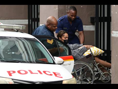 This February 17, 2023, photo shows Jean-Ann Panton being assisted into a Jamaica Constabulary Force vehicle to depart the Supreme Court. A second application for bail by her attorney was denied by the judge when she appeared in court yesterday.