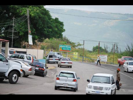 This Gleaner file photo shows traffic passing through Junction, St Elizabeth. There are calls for traffic lights to be installed to regulate traffic in the growing town.