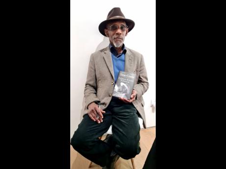 Linton Kwesi Johnson holds a copy of his new book ‘Time Come:  Selected Prose’.