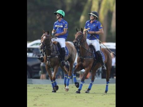 
Jason Waite (right) and a fellow team Park Place member share a light moment during a polo game recently.