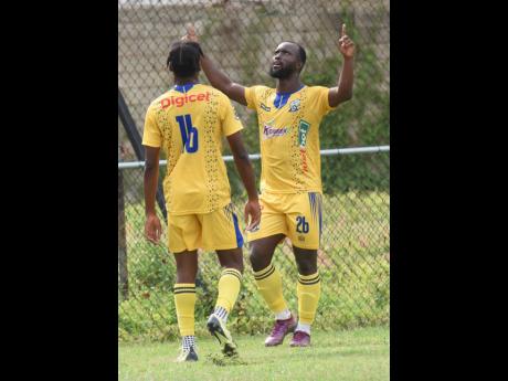 Jason Wright (right) of Molynes United  reacts after scoring his third goal against Tivoli Gardens during their Jamaica Premier League football match at the Waterhouse Mini Stadium yesterday. At left is his teammate Nevardo Blair.