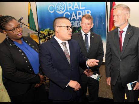 Senator Matthew Samuda (second left), minister with responsibility for the environment, chats with (from left) Shenique Albury-Smith, deputy director Caribbean Division of The Nature Conservancy (TNC) Bahamas; Dr Rob Brumbaugh, executive director of TNC Ca