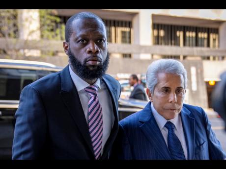 Prakazrel ‘Pras’ Michel (left), a member of the 1990s hip-hop group the Fugees, accompanied by defence lawyer David Kenner (right), arrives at federal court for his trial in an alleged campaign finance conspiracy.  