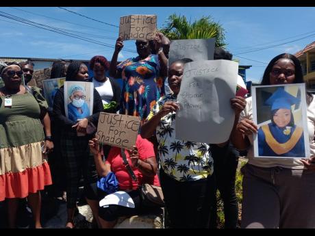 Family and friends of slain surgical nurse assistant Shadae Shari Brown protest outside the Manchester Parish Court on Wednesday morning.