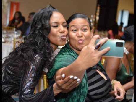 This year’s The Distinguished awardee in Media and Comminucations, Terri-Karelle Reid (left), takes a selfie with The Original Arm Candy’s Gianna Fakhourie, the 2018 The Distinguished awardee in the field of fashion. 