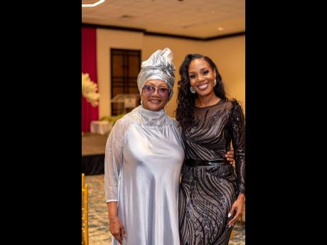 The Distinguished Pioneer awardee  for Entertainment, Marcia Griffiths (left), poses with Terri-Karelle Reid, who received The Distinguished Award for Media and Communications. 