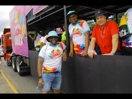 Minister of Tourism, Edmund Bartlett (centre) shares a moment with Minister without Portfolio in the Ministry of Economic Growth and Job Creation, Matthew Samuda (right), and Director of Tourism, Donovan White, during the recent Carnival in Jamaica, Road M
