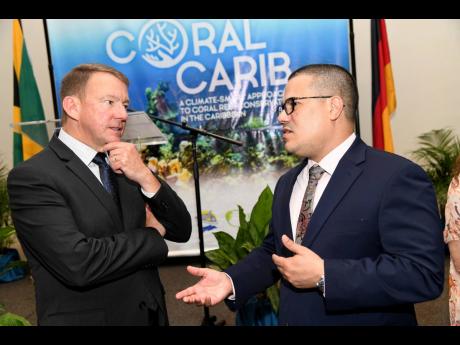 Senator Matthew Samuda (right), minister without portfolio in the Ministry of Economic Growth and Job Creation with responsibility for the environment, speaks with Dr Rob Brumbaugh, executive director of TNC Caribbean Division at the launch of the Nature C