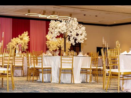 Standing out amongst seats of gold, the white cherry blossom trees provided enchantment to the decor.