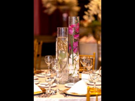 Water-submerged flora and fauna placed in cylindrical vases added elegance and flair to the distinguished event.