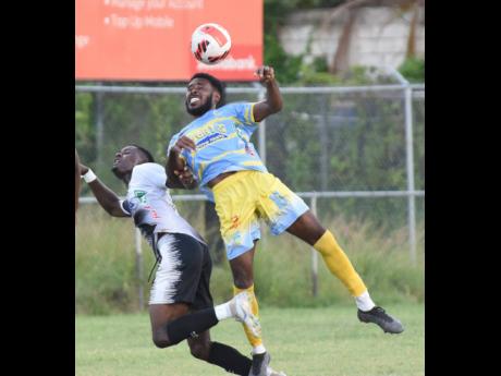 
Denardo Thomas (right) from Waterhouse outjumps Kyle Ming (left) from Cavalier for the ball during their Jamaica Premier League football at the Waterhouse Mini Stadium last Sunday.