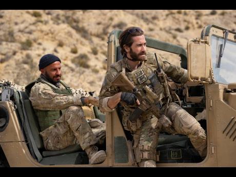  Dar Salim as Ahmed, left, and Jake Gyllenhaal as Sgt John Kinley in a scene from ‘Guy Ritchie’s The Covenant’.