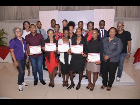 Kim Mair (left), CEO of the JMMB Joan Duncan Foundation, and board of directors (right) Audrey Deer- Williams and Douglas Lindo with the 2022-23 scholarship awardees.